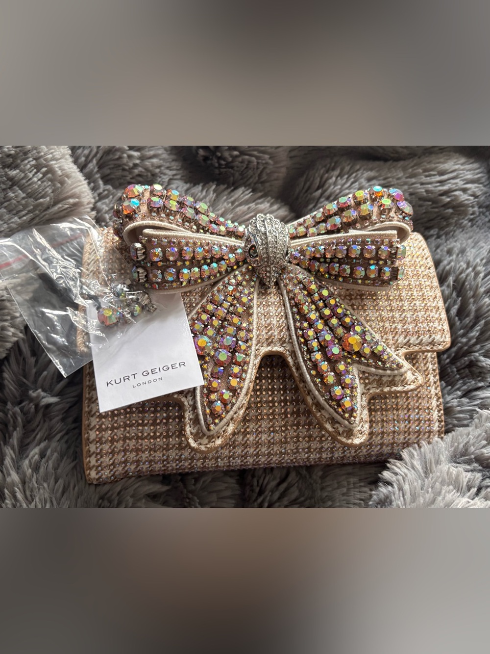 Kurt Geiger iridescent crystal bow clutch in rose gold tones
